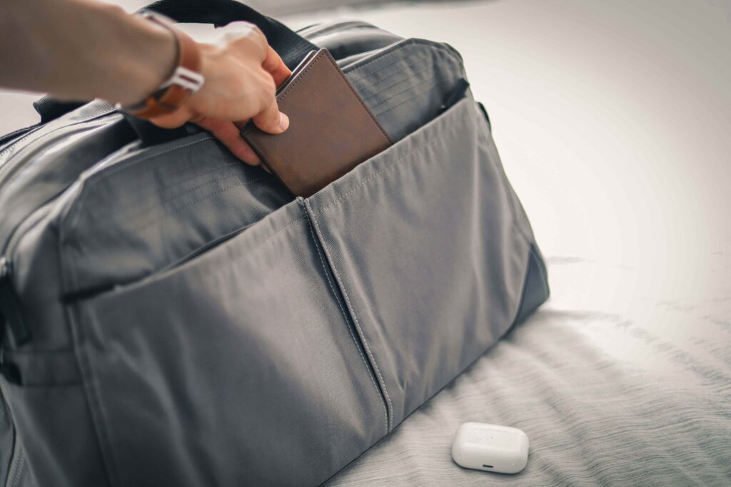 Putting passport and documents into a personal bag to keep them off the moving truck