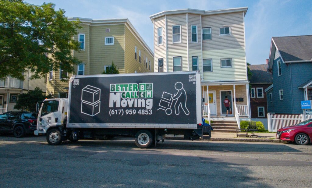 Better Call Moving truck parked at the curb in front of a Boston triple-decker on moving day