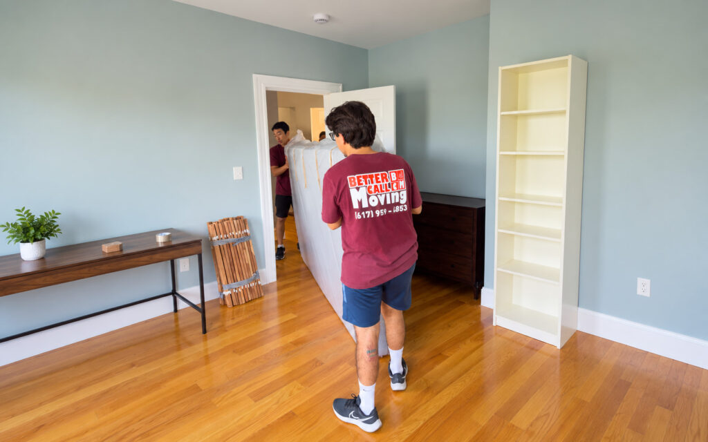 Better Call Moving crew carrying a mattress into a bedroom of a new home